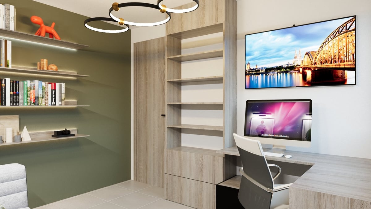 Modern office nook with green accent wall, floating shelves, desk with dual monitors, and pendant lighting
